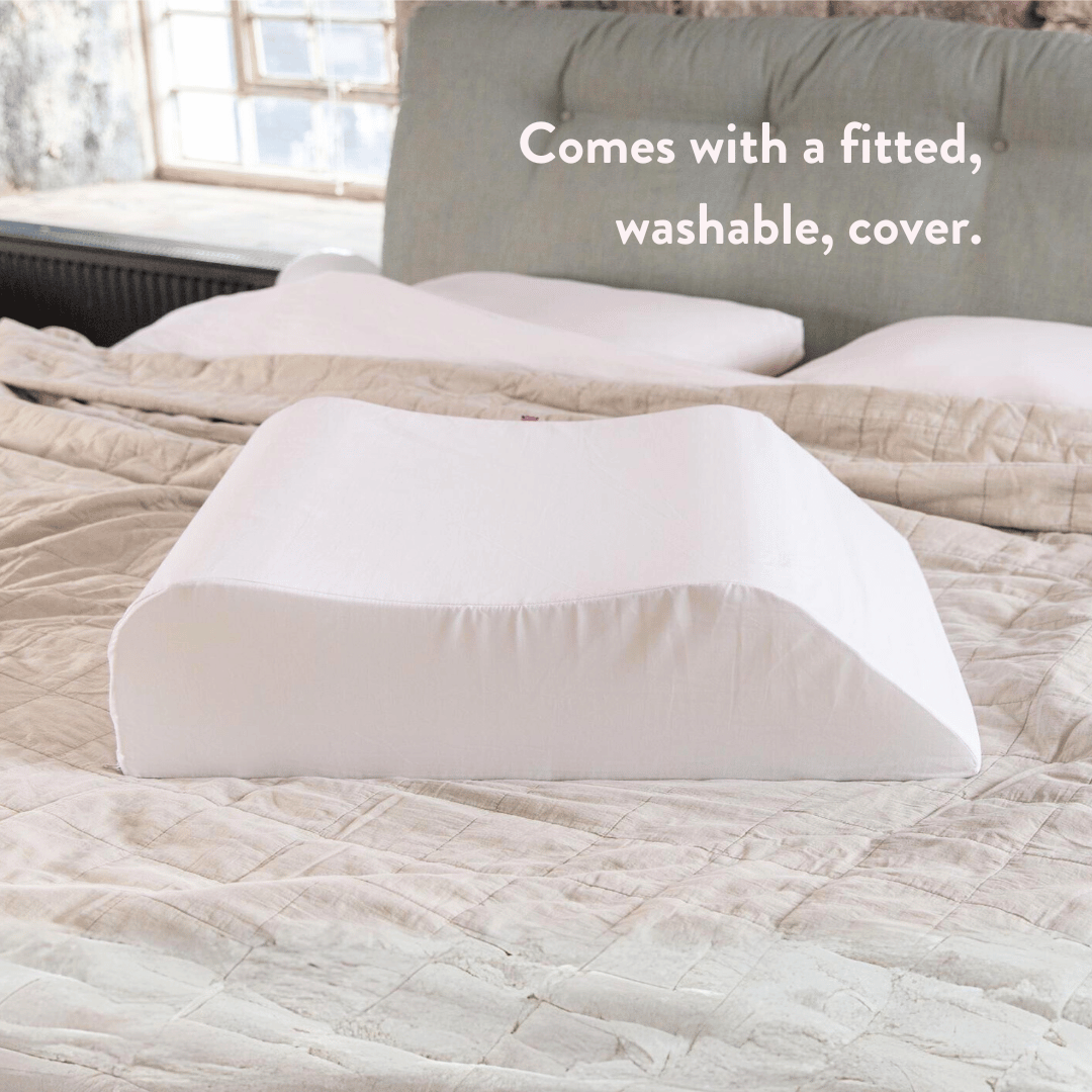 Putnams contoured leg rest pillow on a bed (image 4)